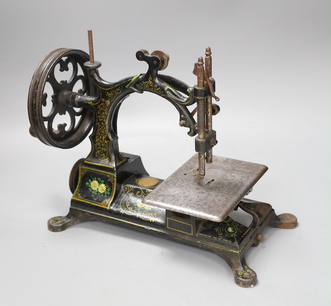 A Hurtu (French) floral painted iron sewing machine, 27cm tall